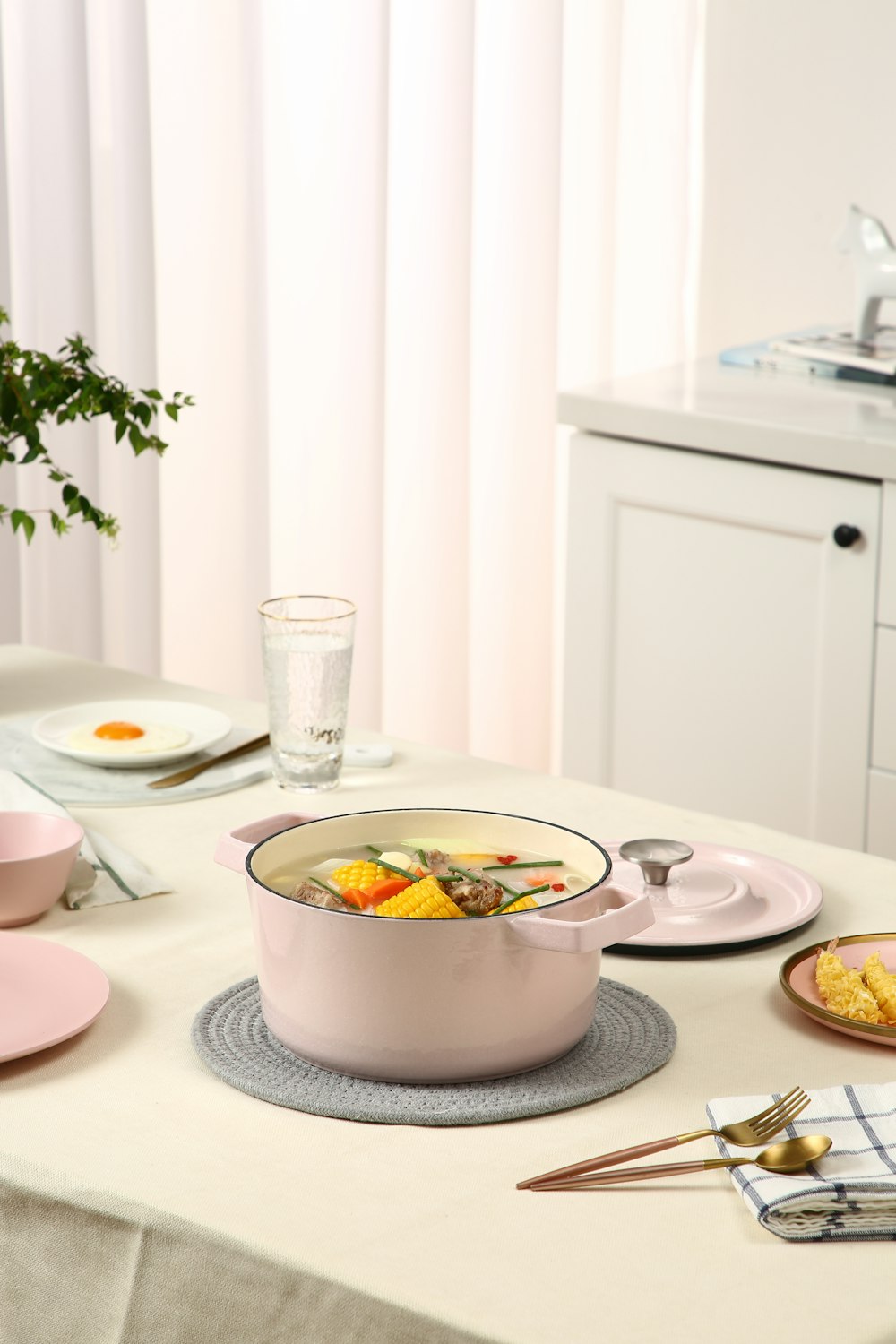 clear drinking glass beside white ceramic bowl on table