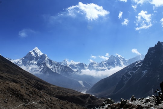 snow covered mountains under blue sky during daytime in Ama Dablam Nepal
