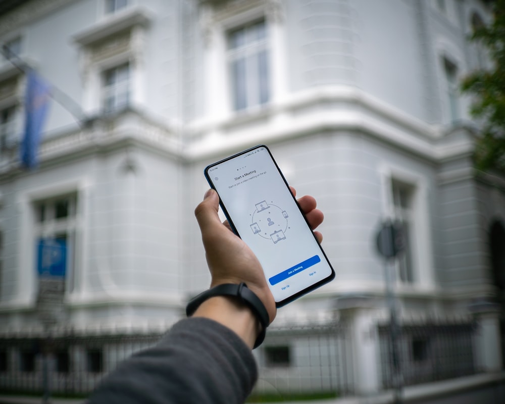 person holding white android smartphone