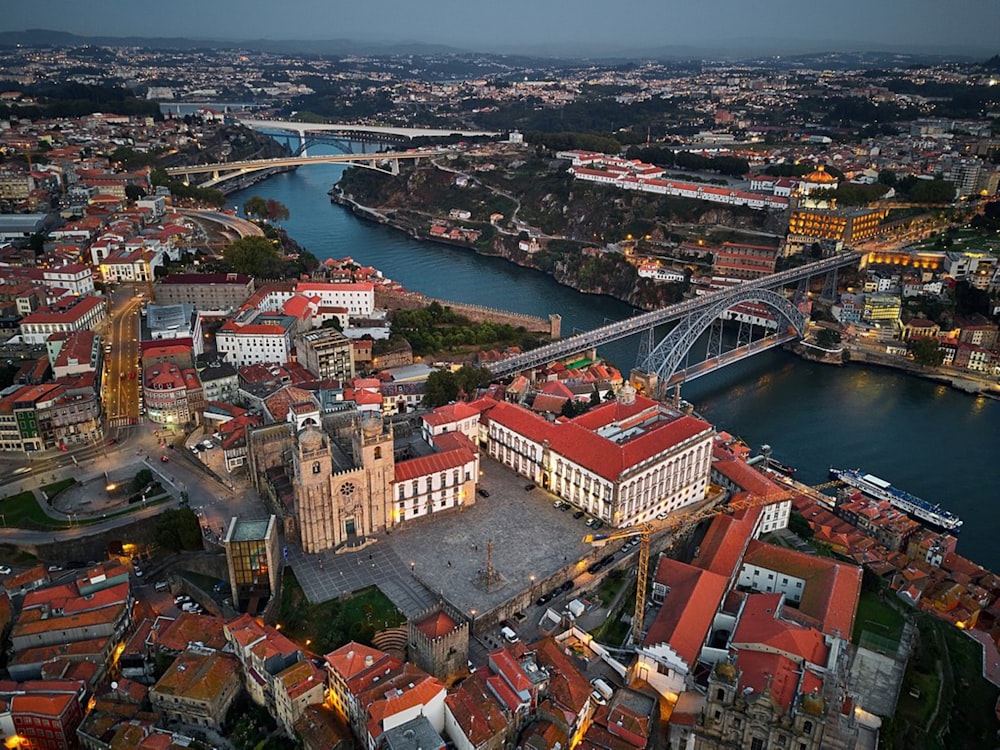 aerial view of city buildings near bridge during daytime