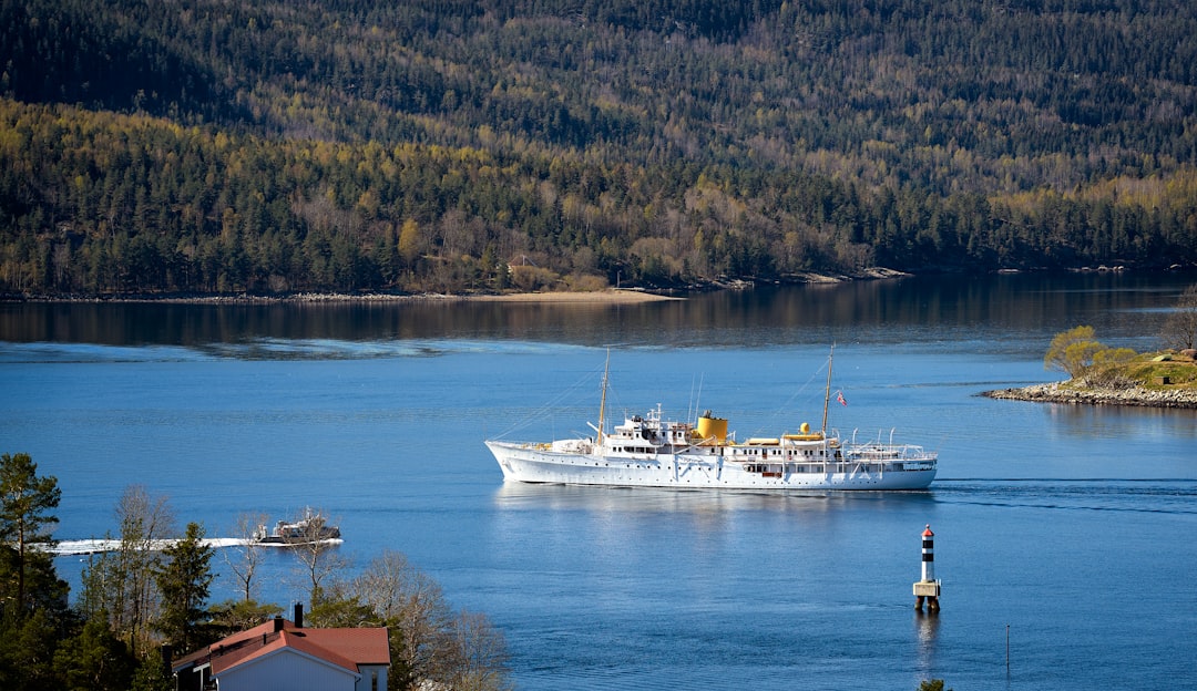 white and brown boat on body of water during daytime