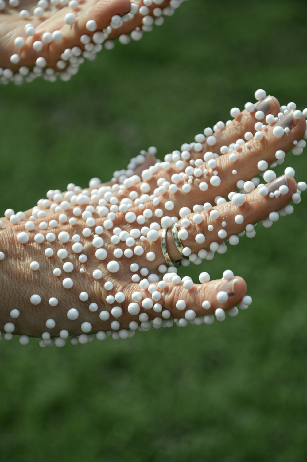 hand covered in polystyrene balls