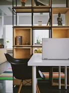 white laptop computer on white table