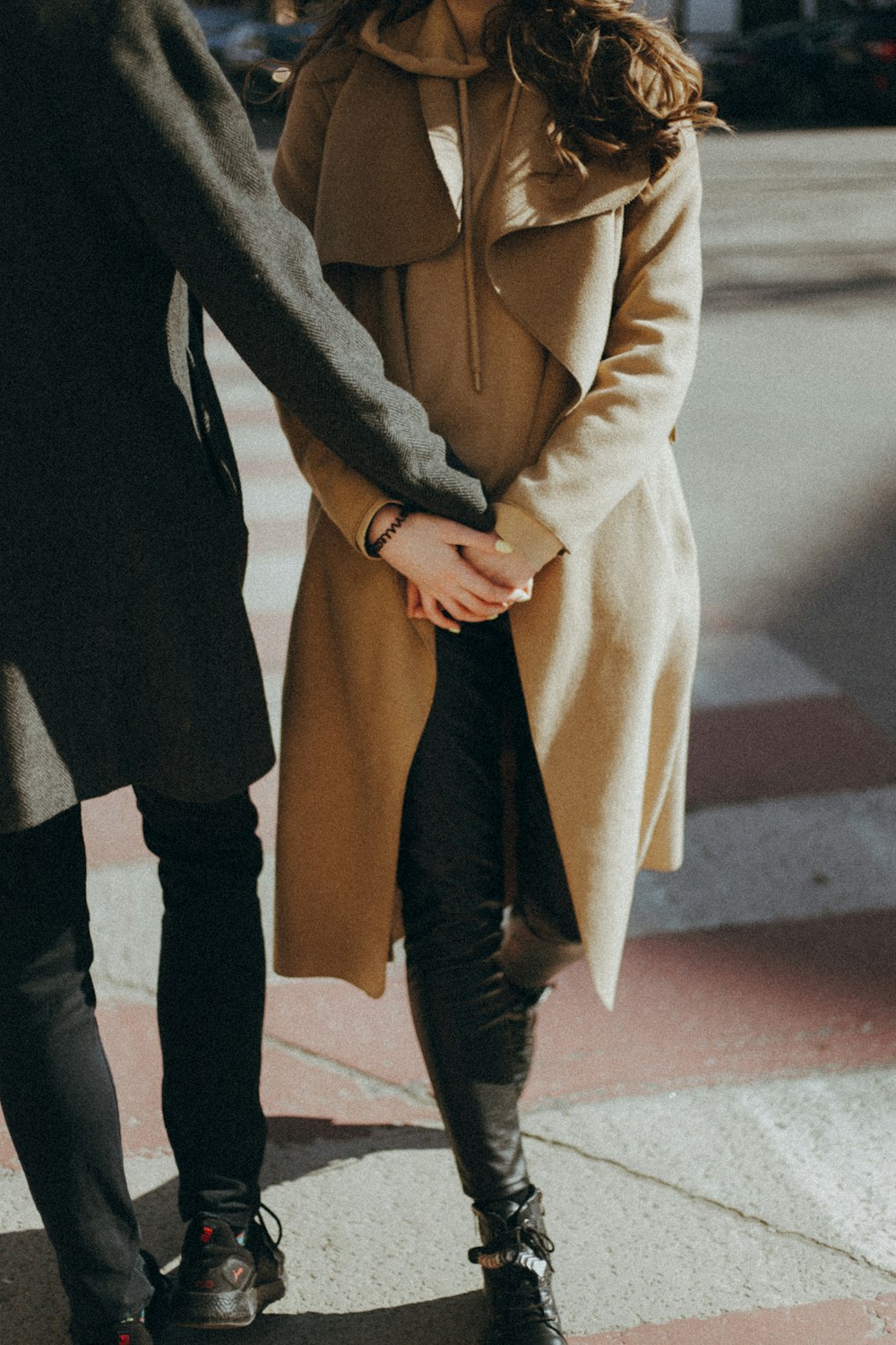 person in brown coat and black pants