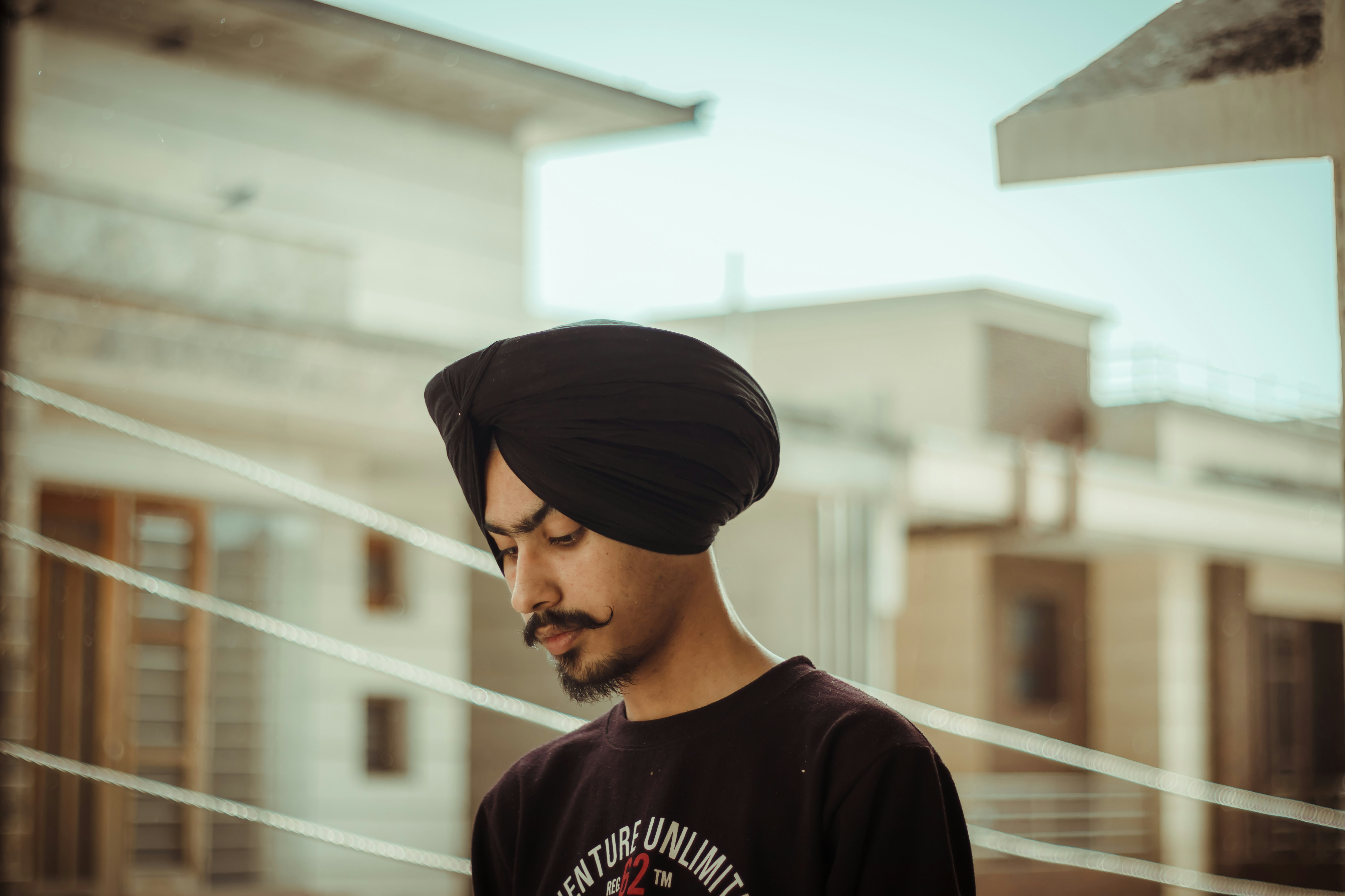 man in black and white crew neck t-shirt wearing black cap