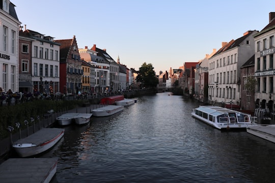 white boat on river near buildings during daytime in Korenmarkt Belgium