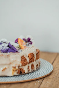 Close-up of a beautifully decorated layered cake with soft pastel frosting.