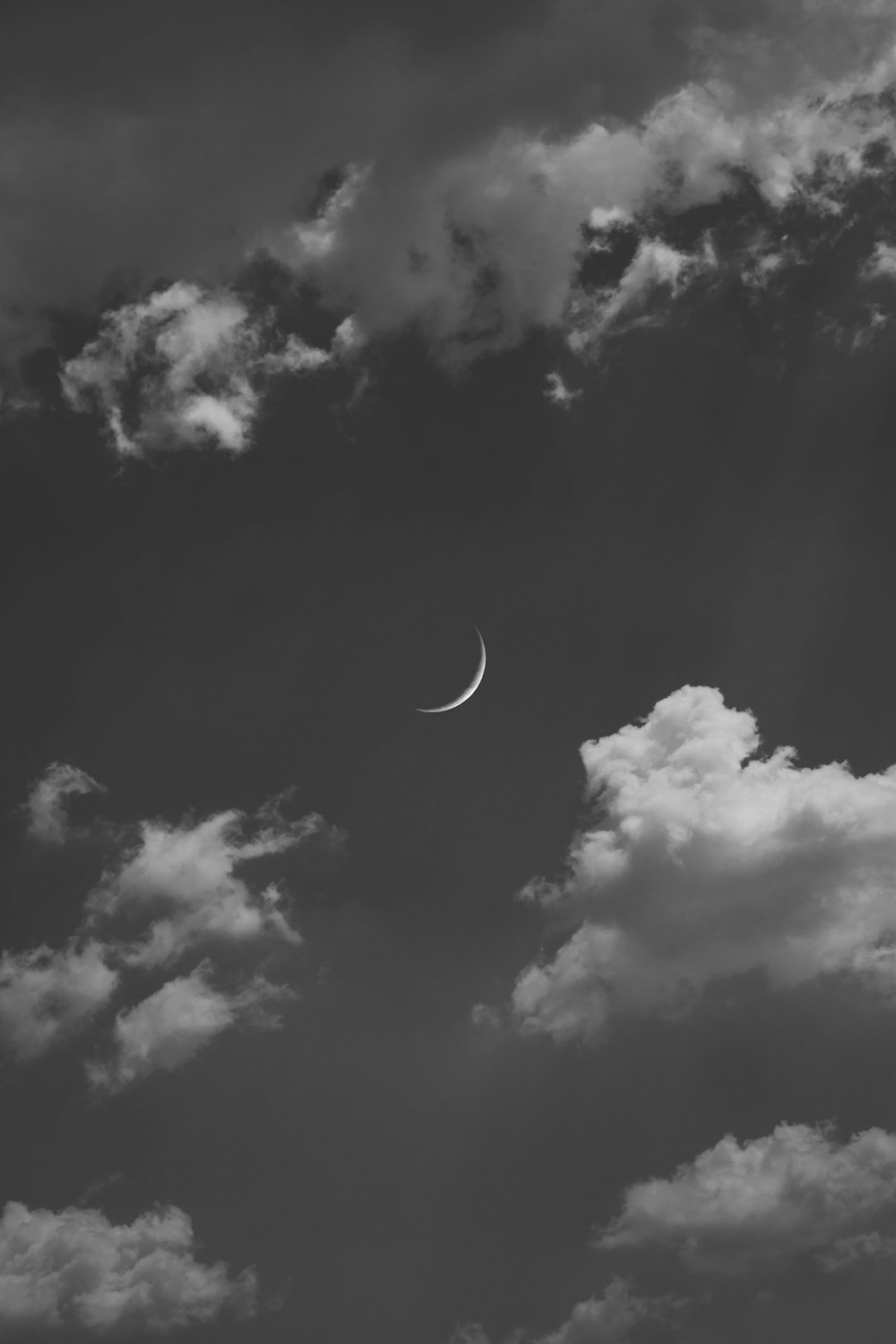 grayscale photo of moon and clouds