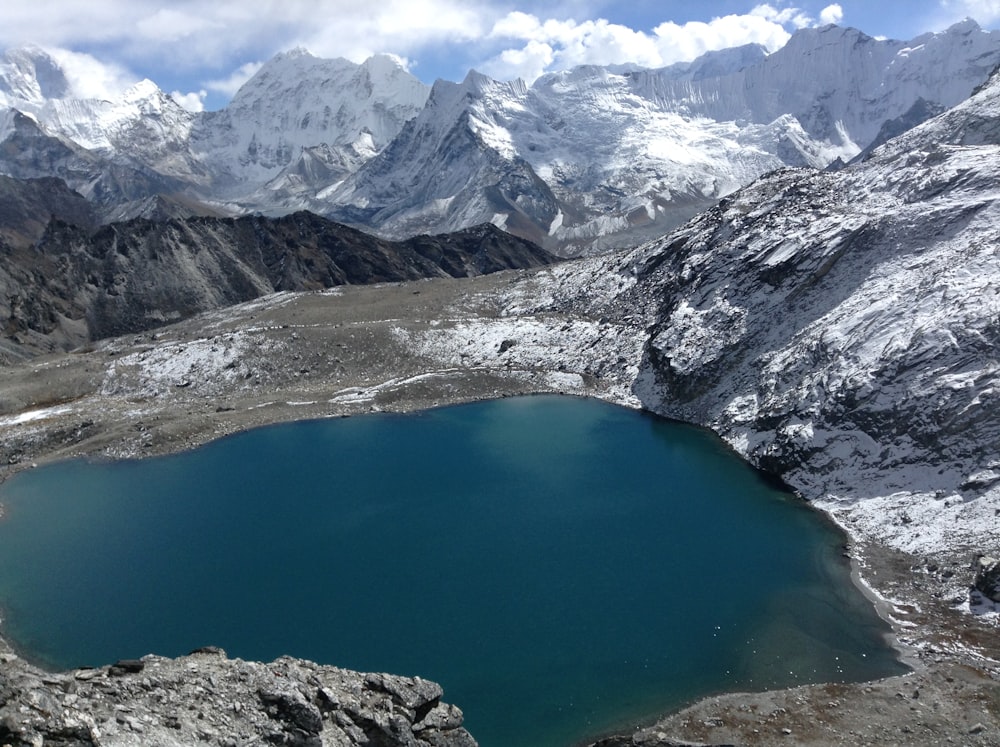 blue lake surrounded by mountains during daytime