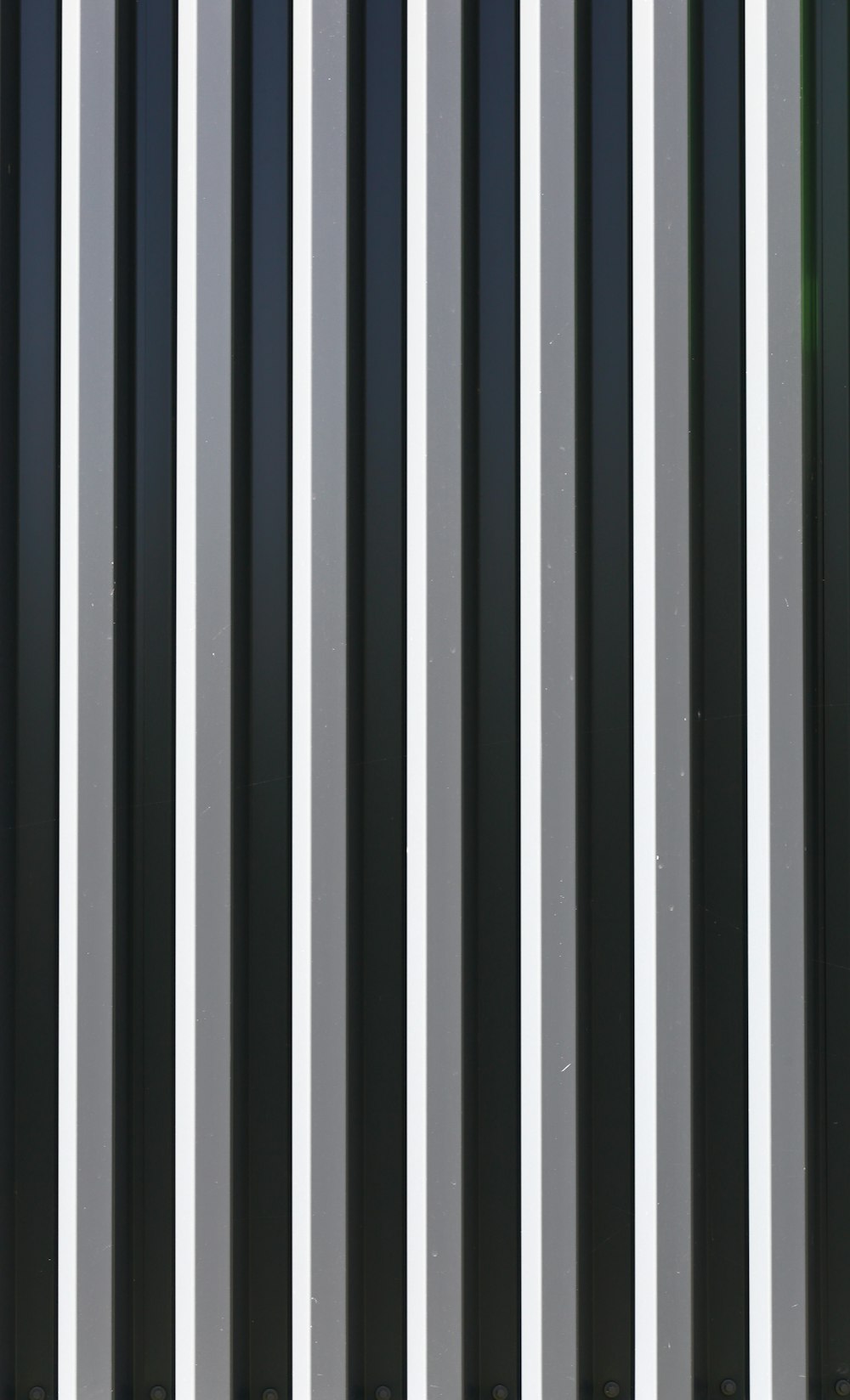 black white and green striped textile