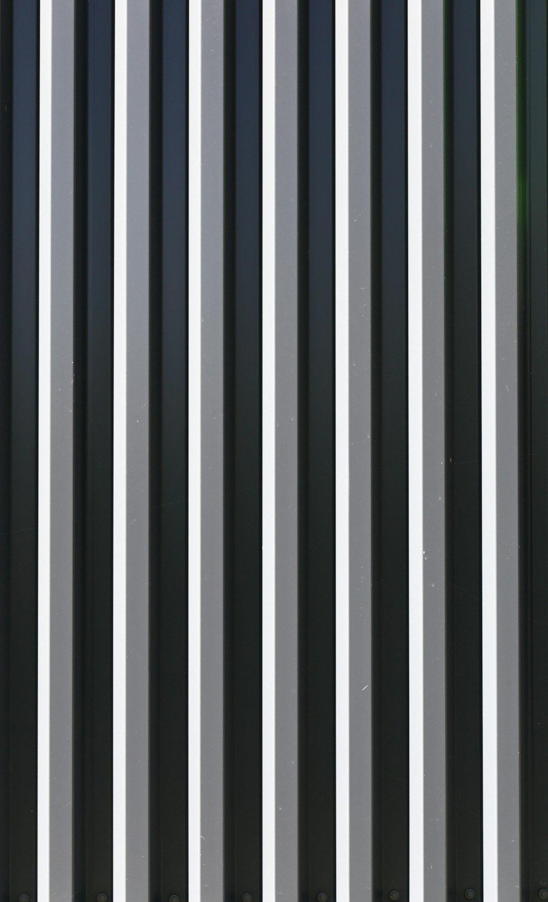 black white and green striped textile