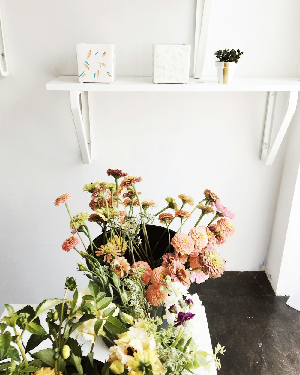 pink and white flowers on white wooden table