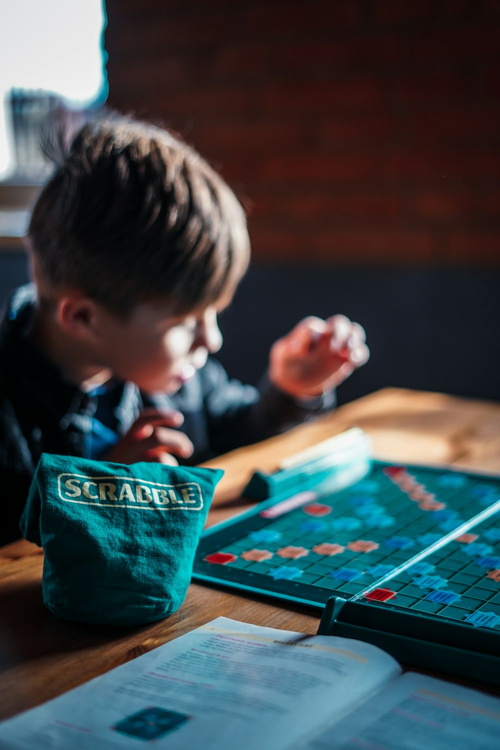 boy playing game on table
