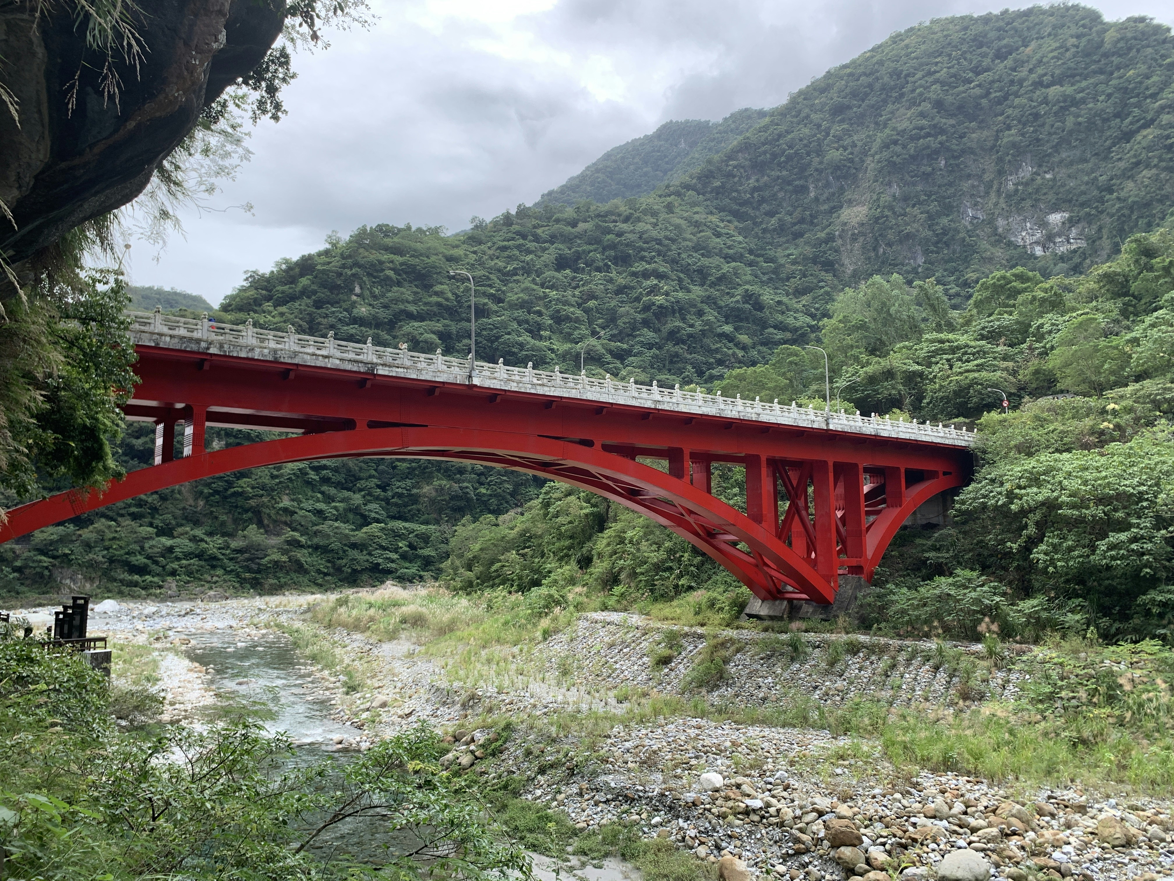 red metal bridge over the river