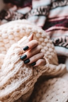 person wearing white knit sweater