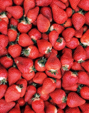red strawberries on white ceramic
