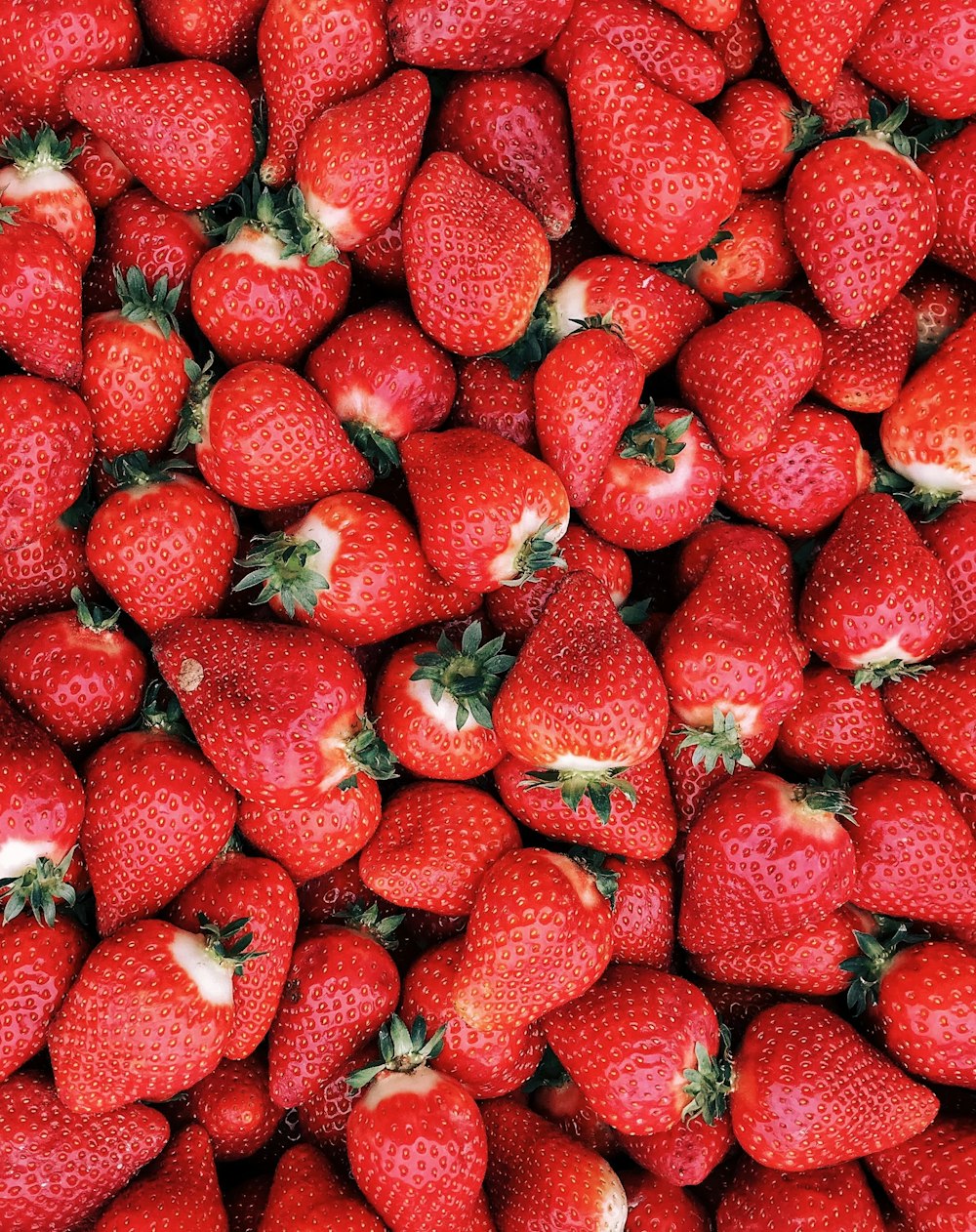 red strawberries on white ceramic plate