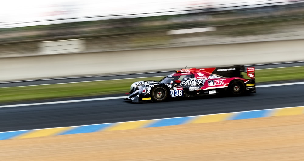 black and red f 1 car on road