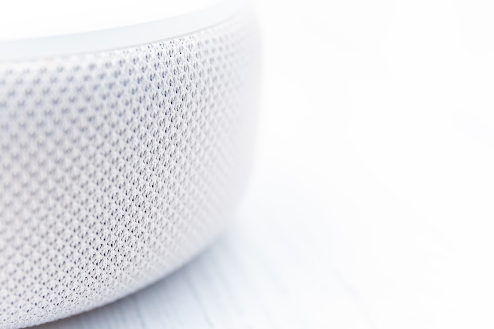 white round speaker on white surface