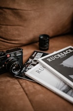 black and white camera lens on white book