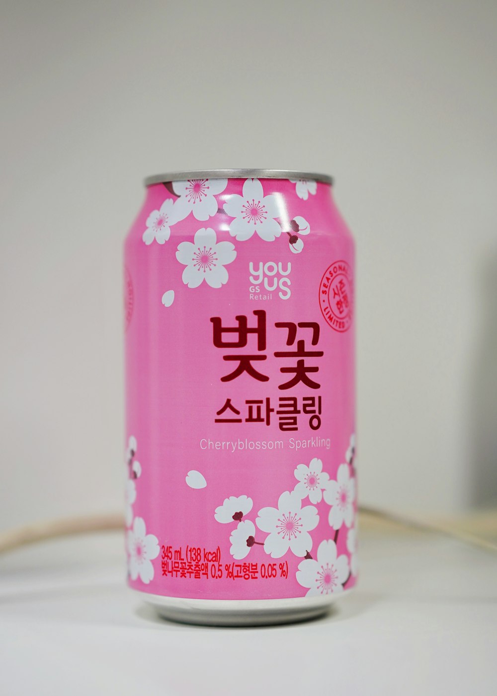 pink and white labeled can