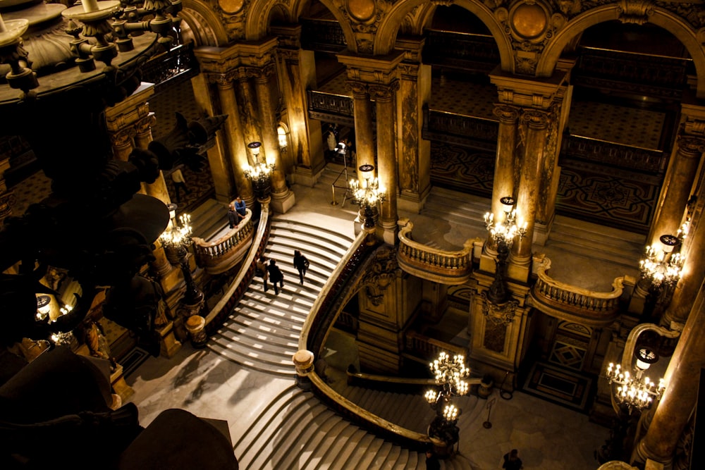 people walking on brown wooden stairs