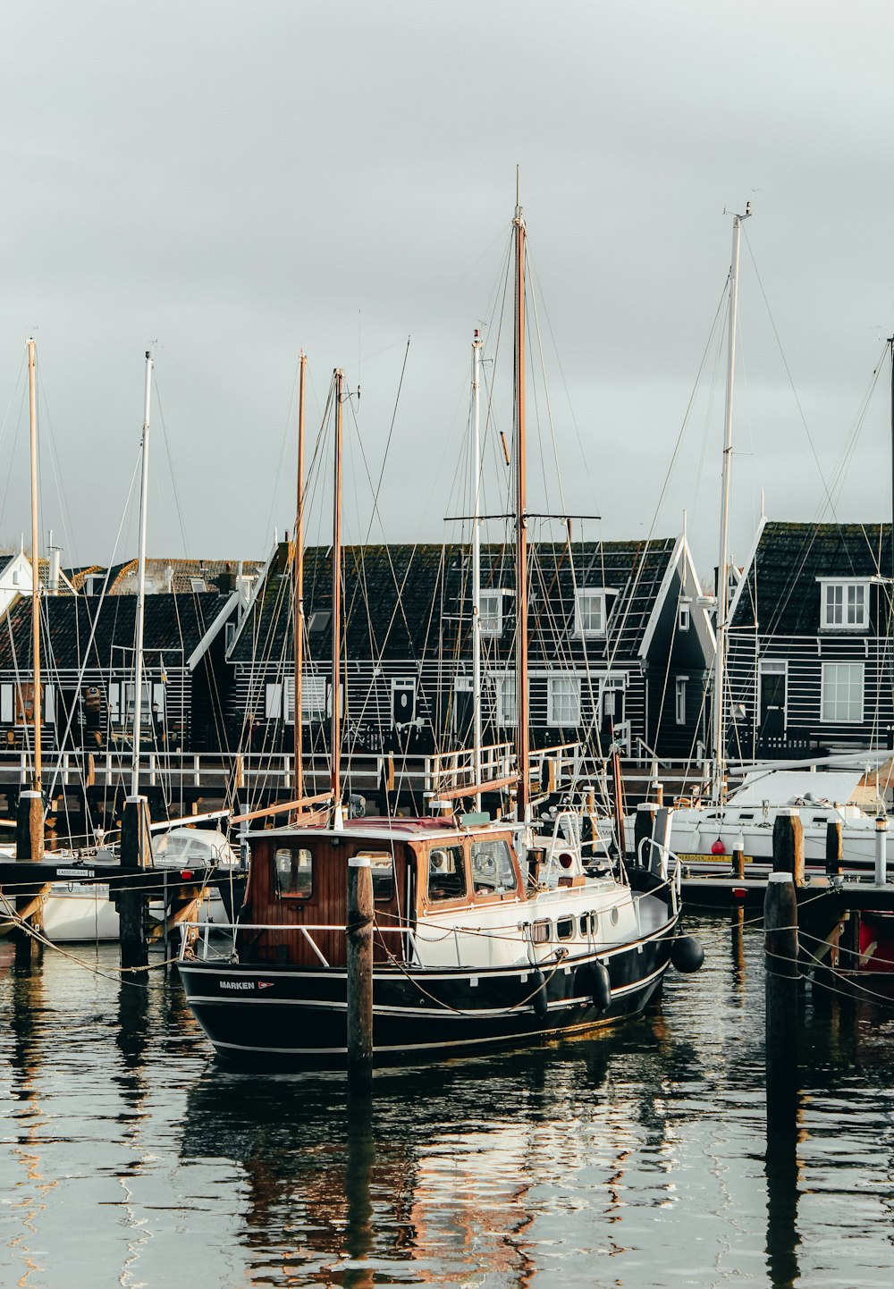 white and brown boat on dock during daytime