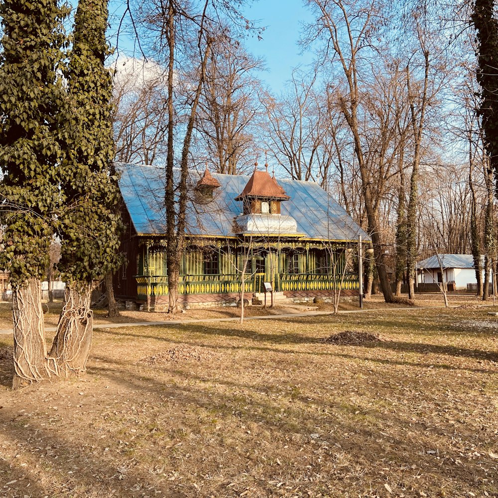 brown and white wooden house near trees during daytime