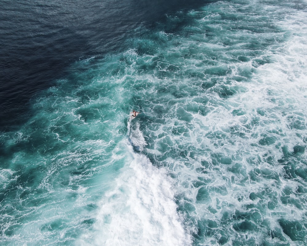 a person riding a surf board on a body of water