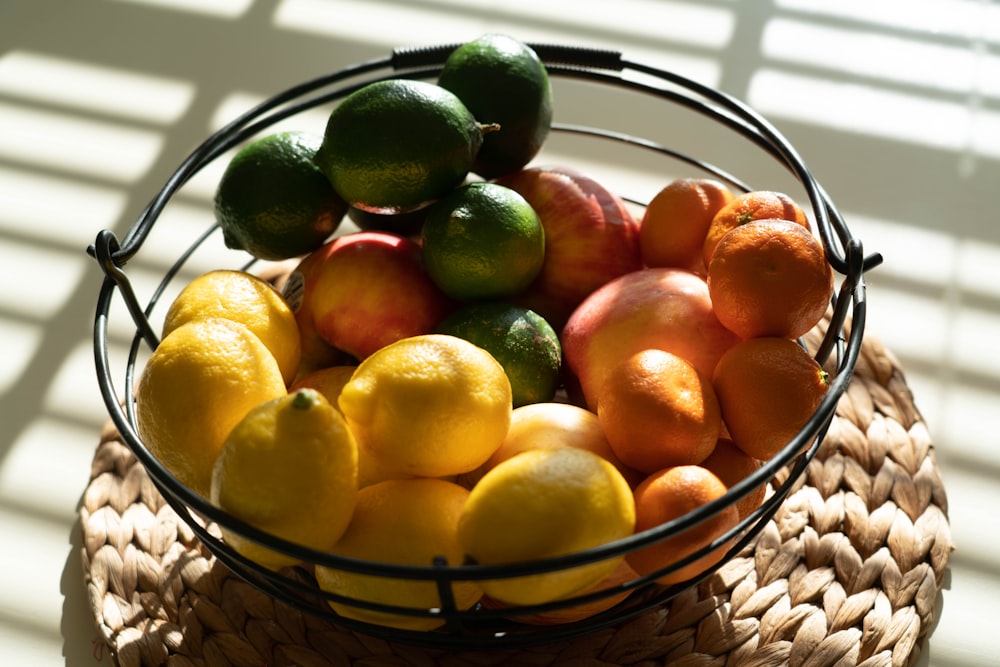 yellow and red apples on brown woven basket