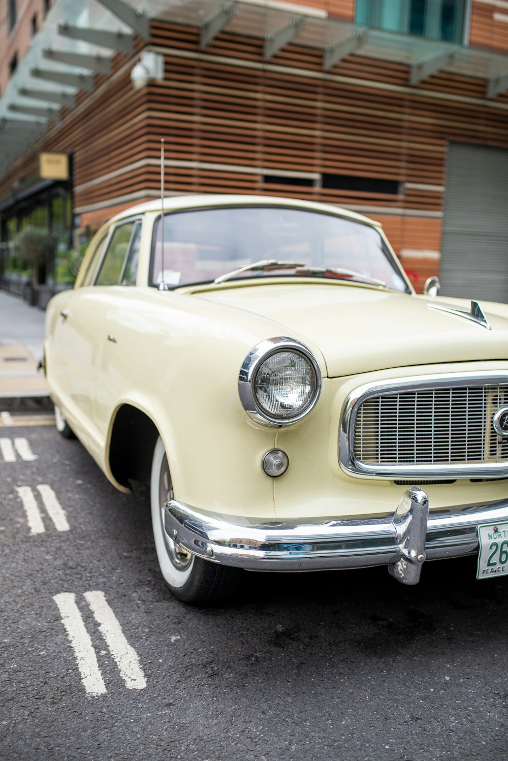 yellow classic car parked on the side of the road during daytime