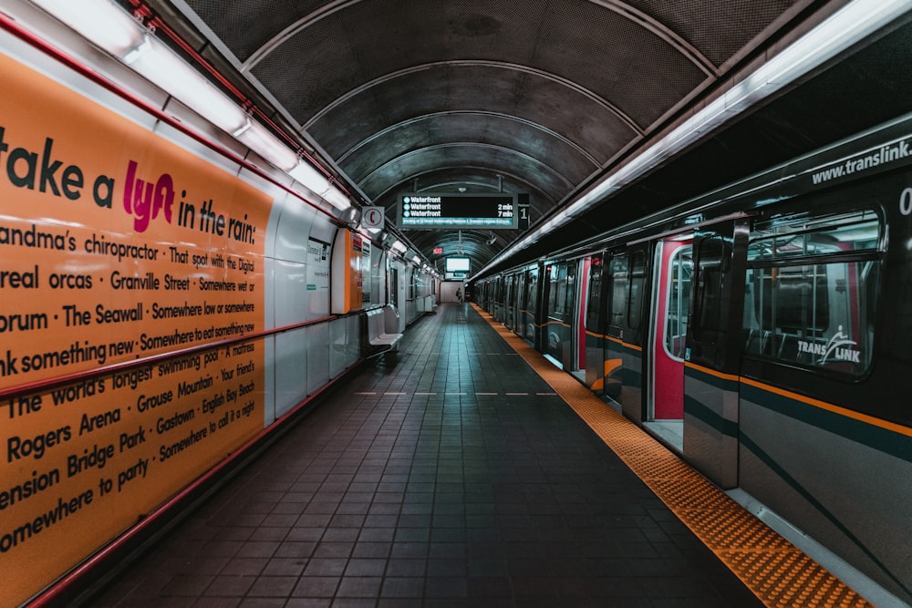 orange and black train in train station