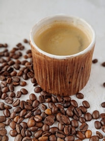 Close-up of a beautifully arranged coffee cup on a rustic wooden table.