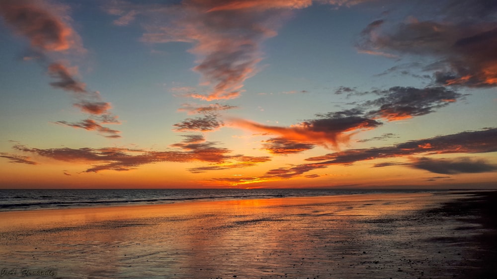 body of water under blue sky during sunset