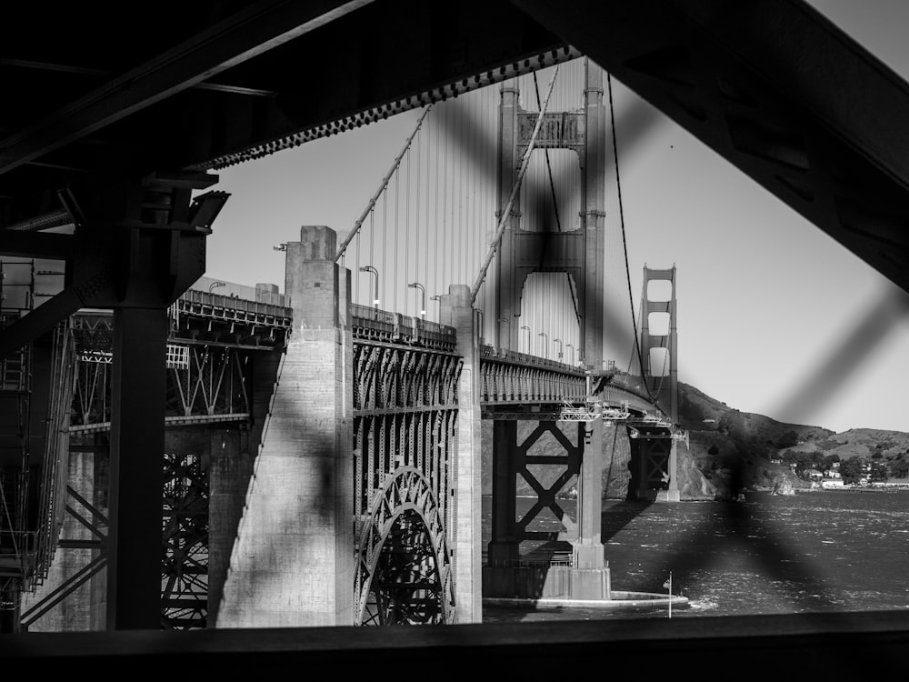 grayscale photo of bridge with cars