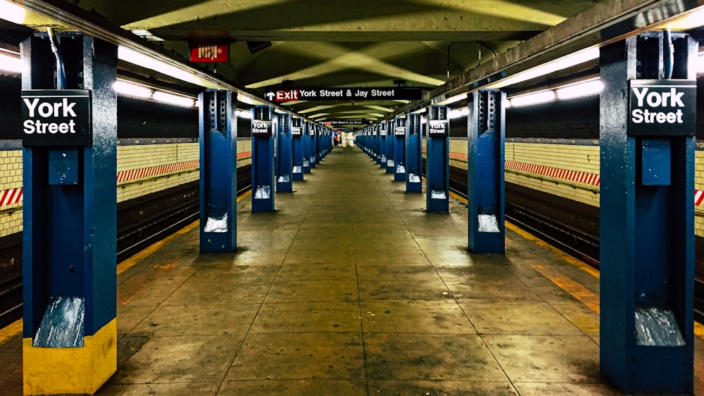 a subway station with blue and yellow stalls