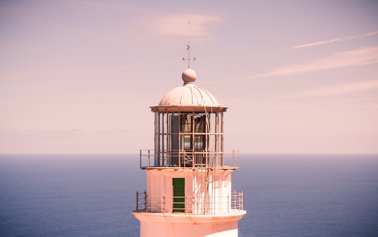 white and brown concrete building on sea during daytime in Faro de Anaga Spain