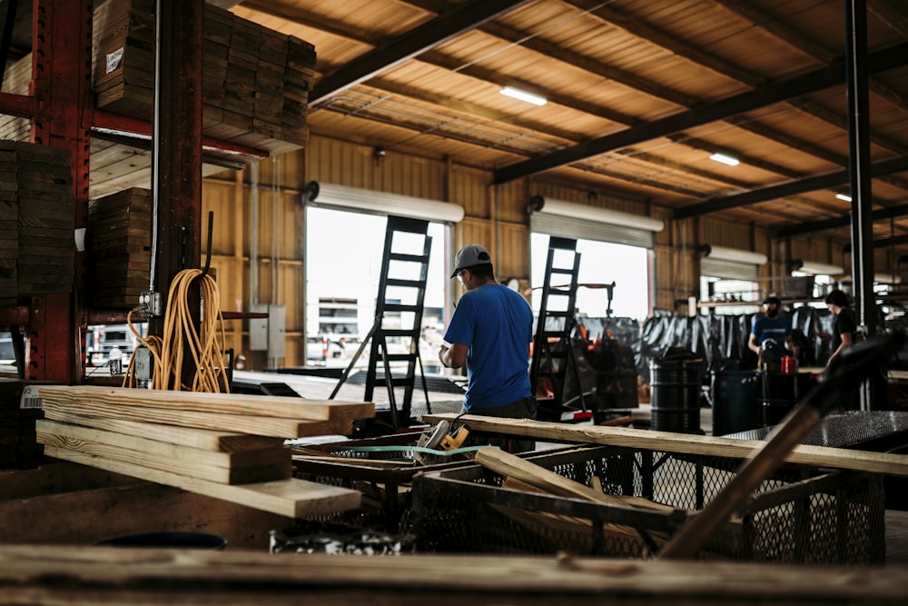 man in blue shirt standing in front of man in blue shirt