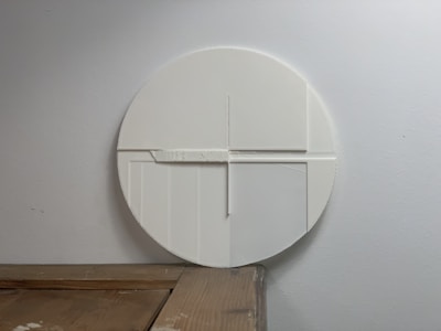 Floating bed positioned against an off-white wall, highlighting its sleek silhouette.