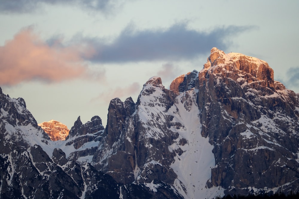 brown and white mountain under cloudy sky during daytime