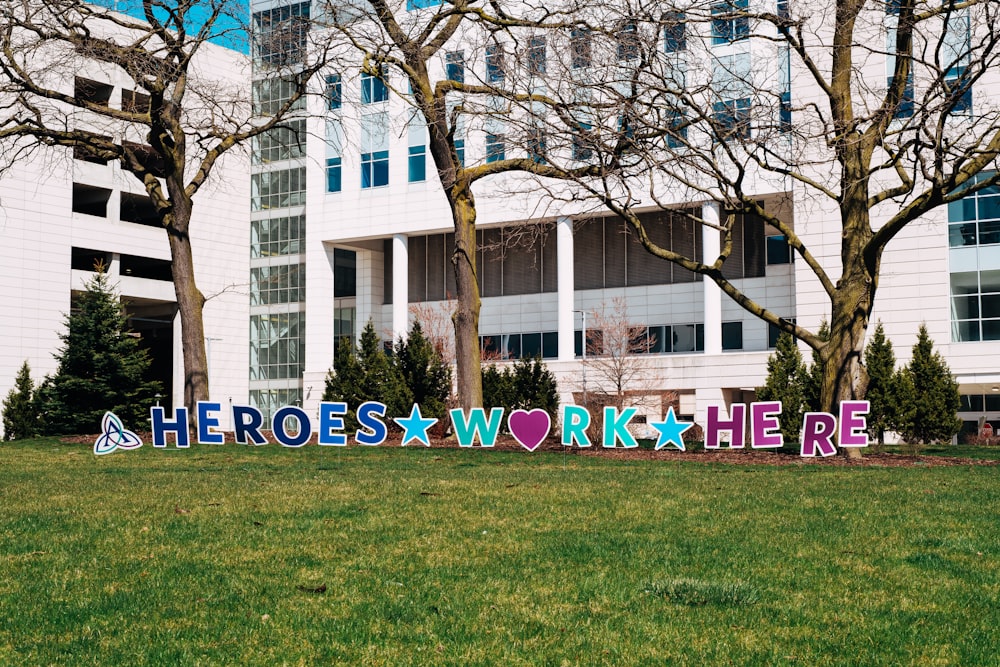 a large sign that says work here in front of a building