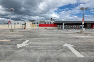 white and red building under white clouds during daytime