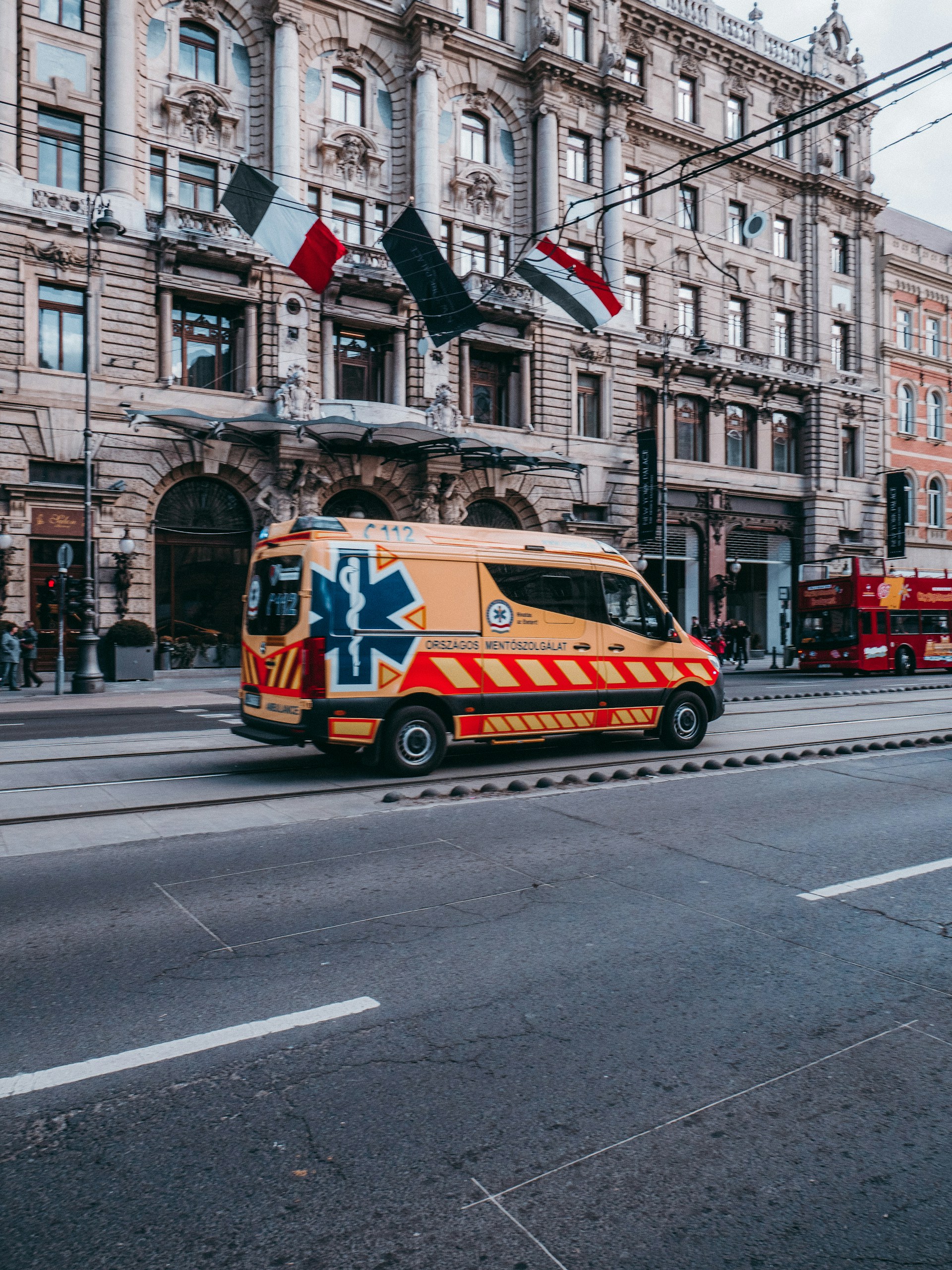 white and red van on road near buildings during daytime
