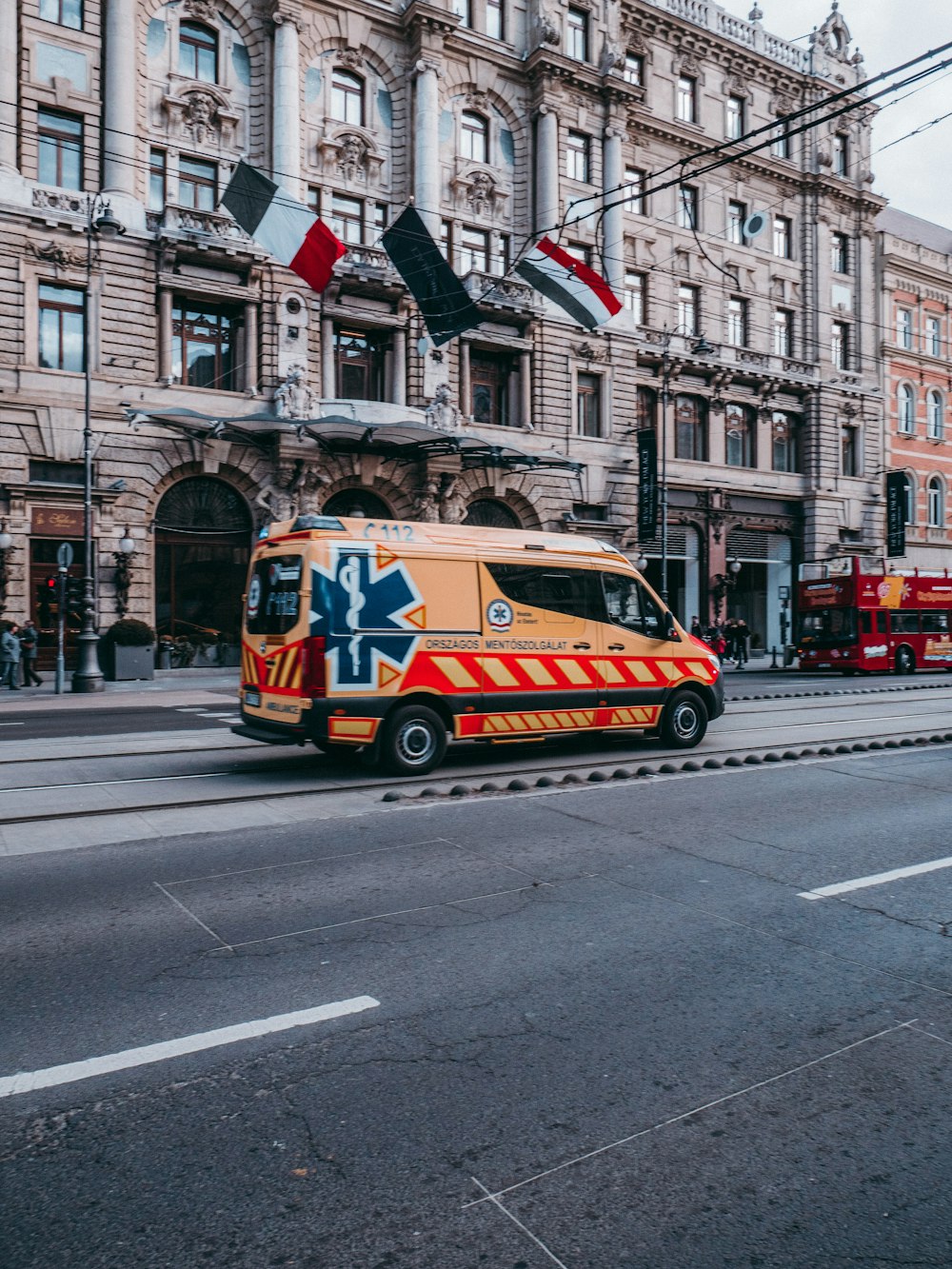 white and red van on road near buildings during daytime