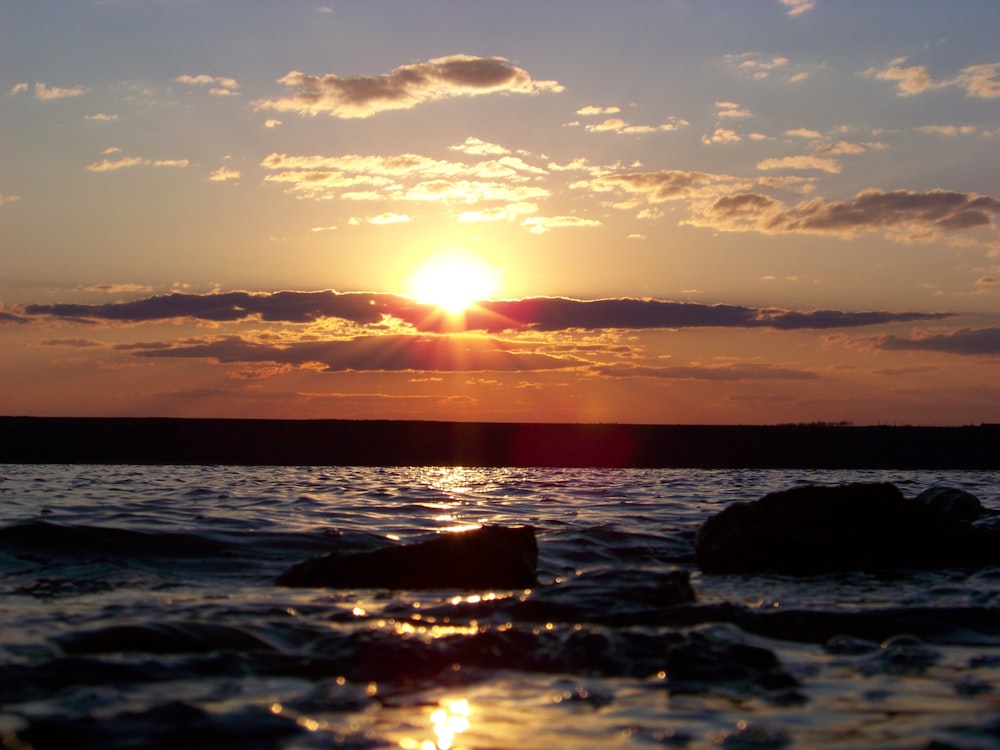 body of water during sunset