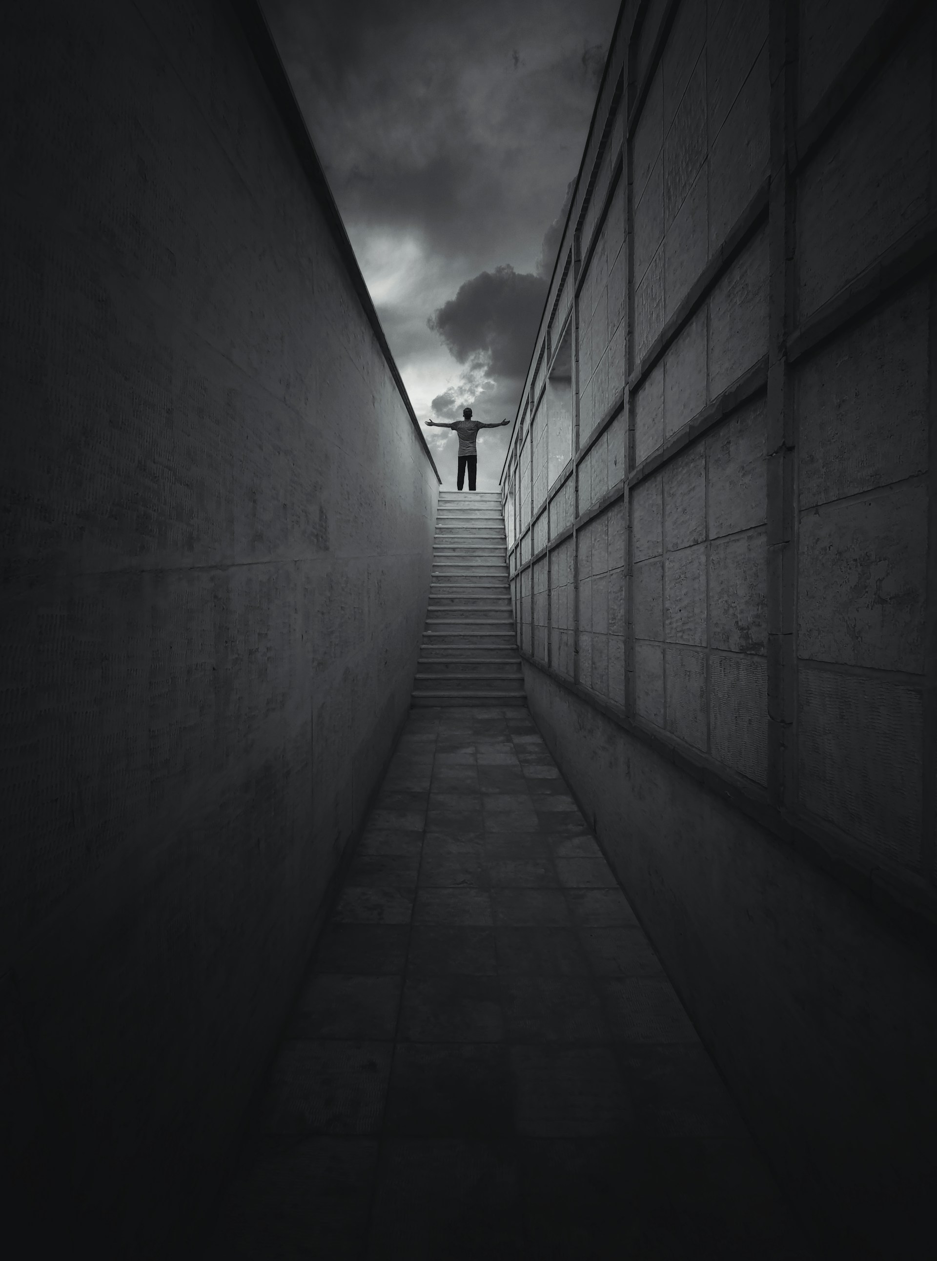 grayscale photo of a tunnel