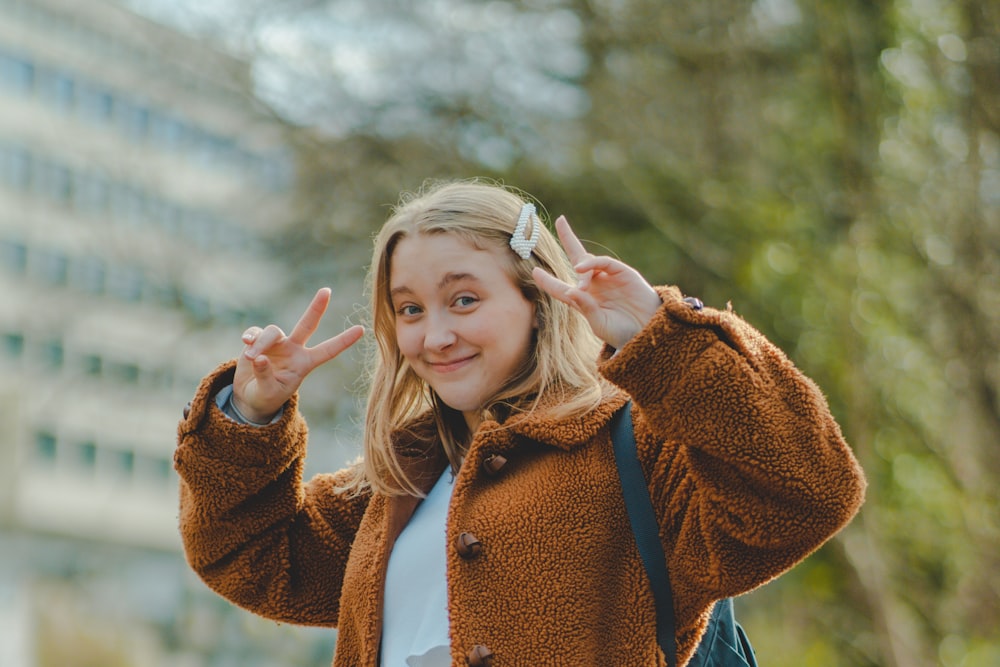 girl in brown coat with white scarf