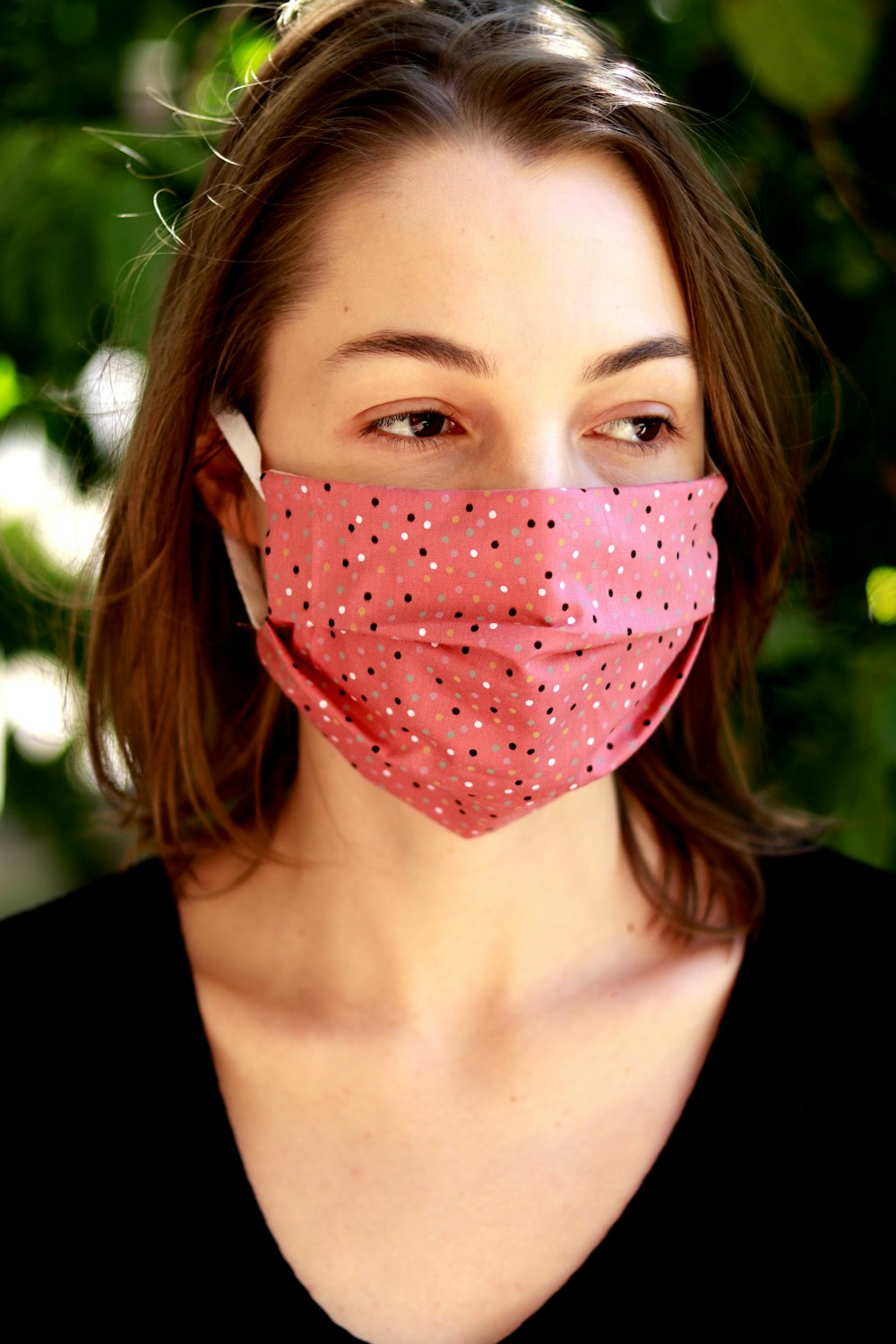 woman with red and white polka dot face paint