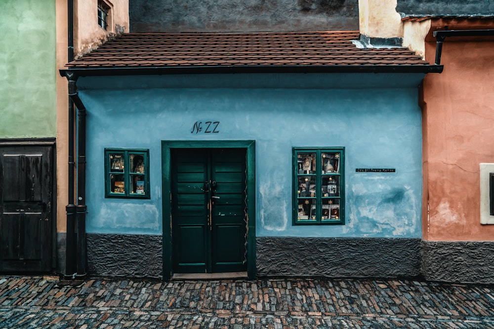 black wooden door on brown brick wall