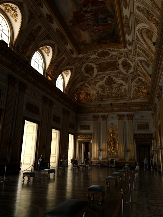 people walking inside building during daytime in Palace of Caserta Italy